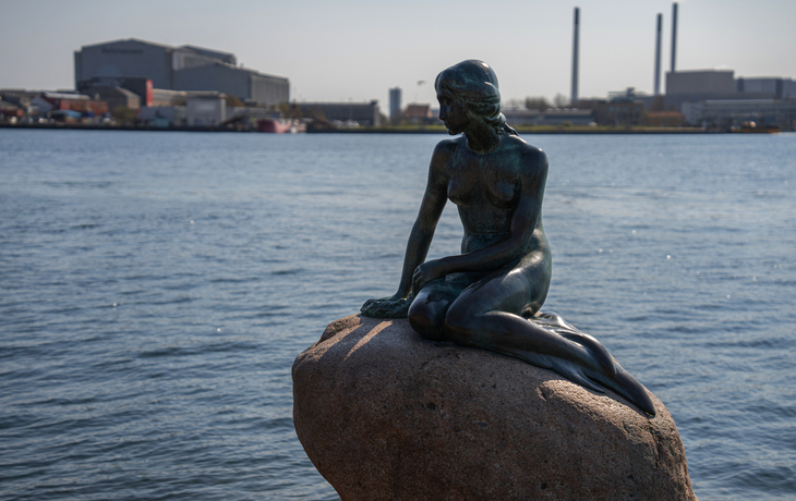 Statue der kleinen Meerjungfrau mit Blick auf den Hafen in Kopenhagen